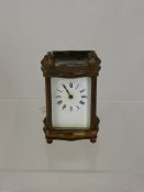 Vintage brass continental carriage clock having shaped face and top (W A F)