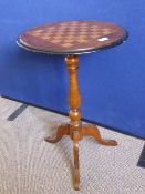 A mahogany games table with tripod base, turned column, chess board inlay to top, possible