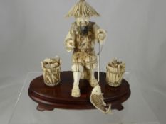 A Bone Study of a Fisherman, seated on a hard wood base with character marks to foot, appprox 22 x