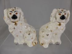 Two Beswick porcelain figures of spaniels, approx. 13 cms in height.
