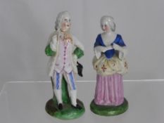 Two continental porcelain figures depicting a gentleman and a lady dressed in their finery, approx.
