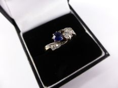 A lady`s 18 carat yellow gold sapphire and diamond crossover ring, sapphire 0.42 cts,, diamond 0.30