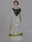 Staffordshire porcelain figurine of Lady Macbeth depicted with a shawl draped over one shoulder,