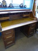 Victorian oak roll top desk, the interior being fitted with two drawers, pen trays and pigeon