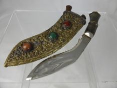 A vintage ""Kukuri"", the Kukuri having a horn handle with lion mask, embossed metal scabbard with