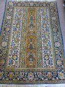 A Persian Carpet, with blue and gold floral design on cream ground, decorative urn design to the