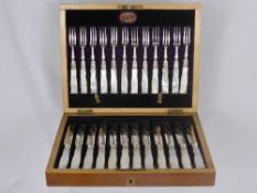 Boxed set of silver plated knives and forks having mother of pearl handles, by James Mark,