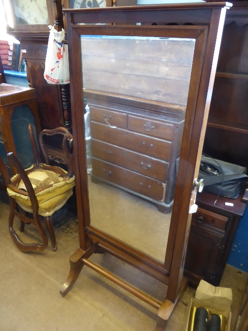 A mahogany Cheval dressing mirror with brass mounts, on casters 165 x  56 cms.