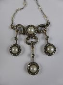 A lady`s 18 carat yellow and white gold, diamond and natural pearl drop necklace, the 1920`s style