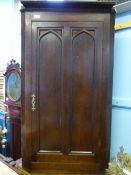Victorian oak corner cupboard having arched panel decoration to the door with three shelves to the