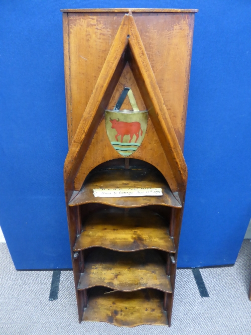 A vintage scull form book case, the four shelf book case adapted from Oxford University scull