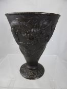 An antique bronze metal vase depicting chasing dragons, character marks to base.