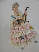 Continental Figure of a Lady, depicted playing the mandolin, nr 1033 approx 15 cm