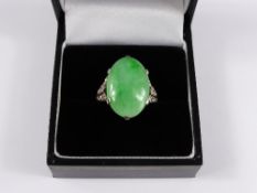 A lady`s 18 carat white gold jadeite and diamond ring, jadeite 12.33 cts, size I, total weight 7.5