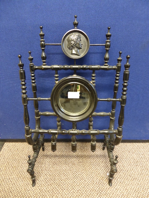 A Regency Canterbury, the ebonised Canterbury having a mirror to front with three mother of pearl