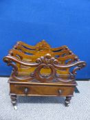A mahogany Victorian Canterbury, the Canterbury having a carved front screen with four segments,