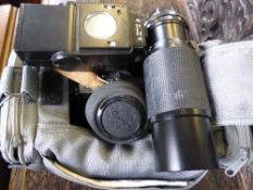 A Vintage Canon AE1 Camera with flash and lenses in the original case with booklet.