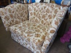Knowle style two seater sofa having drop down sides, covered in beige fabric with green and red