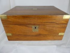 A mahogany veneered writing slope being teak lined with embossed leather to the slope, the box