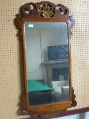 Antique Chippendale style wall mirror, the frame being flamed mahogany with decoration to top and