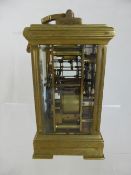 Antique English Brass Carriage Clock, the clock features a feminine enamel face with Roman dial,