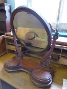 Victorian mahogany oval toilet mirror, the base having two oval lidded compartments, the mirror