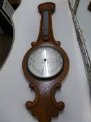 An Edwardian oak cased banjo barometer by William Hume, Edinburgh, the dial 20 cms across, length