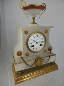 A White Marble Mantle Clock, with a decorative urn to the top, the bell ring and workings stamped