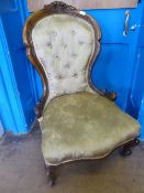 Victorian button back bedroom / nursing chair having carved decoration to front legs with castors,