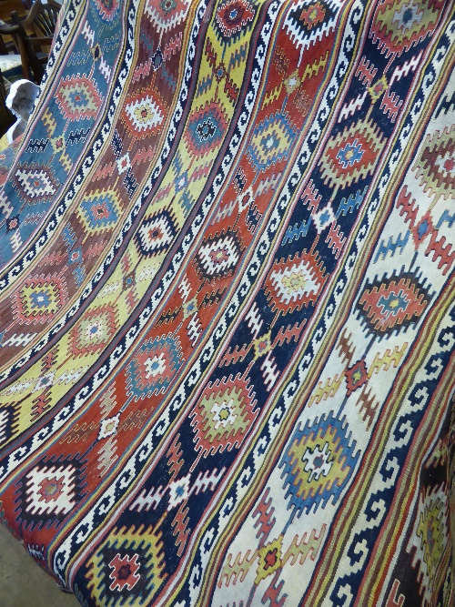 A vintage woollen Kilim carpet 315 x 170  cms, the Kilim having multicoloured ghouls of geometric