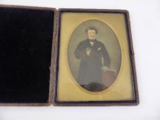 An Edwardian Dagliotype depicting a gent in a frock coat in a velvet lined frame, approx. 14 x 18