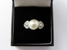 A Platinum and Single Pearl and Diamond Ring, Size K, approx 5.2 gms the pearl 10 mm. 2 x 10 pts