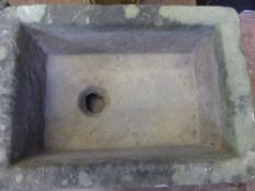 A shallow stone garden trough, approx. 66 x 57 x 18 cms.