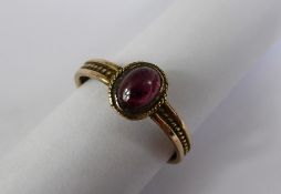 An Antique 9 ct Rose Gold and Cabachon Tourmaline Rope Form Ring, size R, 6.5 x 4.5 mm, approx 2.1
