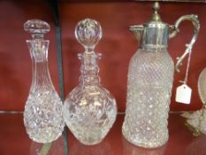 A collection of misc. decanters incl. sunflower design, Waterford sherry and a metal lidded water