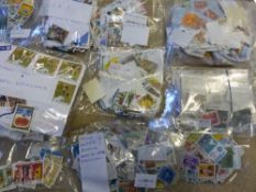 A large collection of stamps in stock books, albums and packets, most commonplace