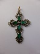 A White Gold and Emerald and Diamond Cross Pendant, set with five tear shaped emeralds with rose cut