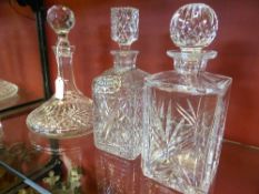 A collection of assorted cut glass and other decanters incl. Thomas Webb whisky ship`s decanter