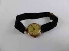 Lady`s 9ct Gold Wrist Watch, having gilded silver dial with blue steel hands on black fabric