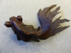 A Chinese Wood Carving of a fantail goldfish with glass eyes.