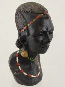 Bust depicting an African woman together with a carved figure of an African lady.