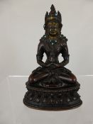 A Circa 17th Century Chinese Sino-Tibetan Gilt Bronze Figure of Buddha, set with turquoise jewels,