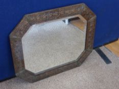 A Copper Arts and Crafts Mirror (Newlyn style), scroll design along the outside edge.