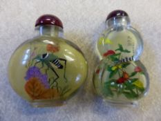 Two Chinese mid 20th Century glass snuff bottles painted with locusts and praying mantis, both