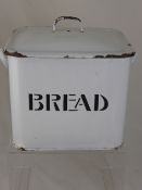 A vintage white enamel bread bin.