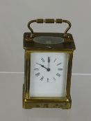 Brass Carriage Clock, having white enamel face with Roman numerals.