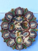 A Majolica Oval plate with a central figure and a high glaze throughout (waf).