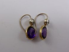 A pair of lady`s 18 ct Gold, Silver and Amethyst Earrings, the amethyst (10 x 8 mm) and the diamonds