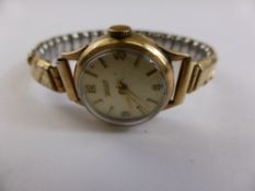 A lady`s 9 ct gold Tissot vintage wristwatch, the case engraved Dennison 77719 A L D 928556