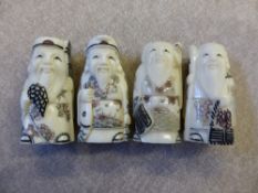 Four hand carved bone Netsuke depicting sages in various poses.